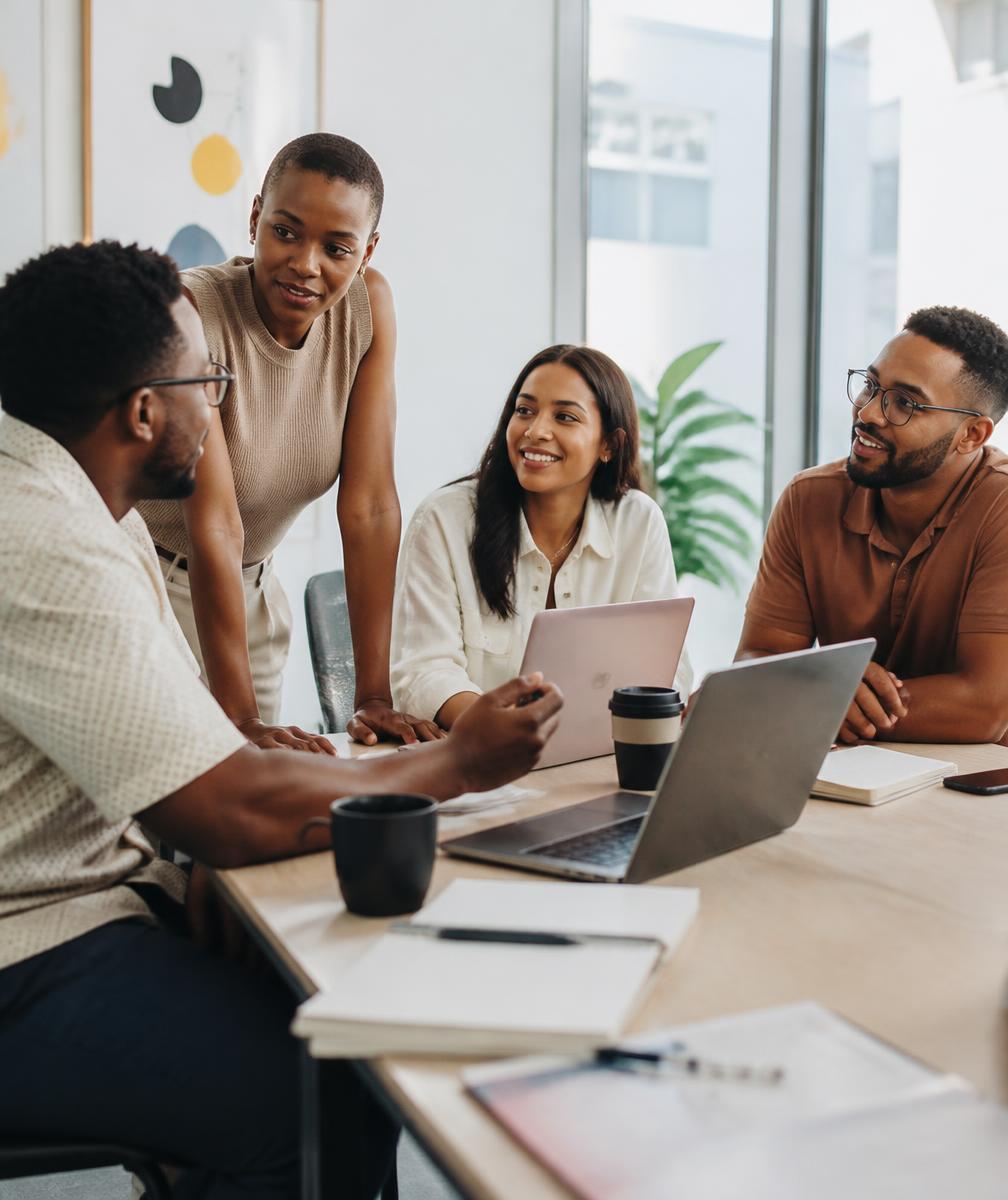 Small team talking together at a bright table