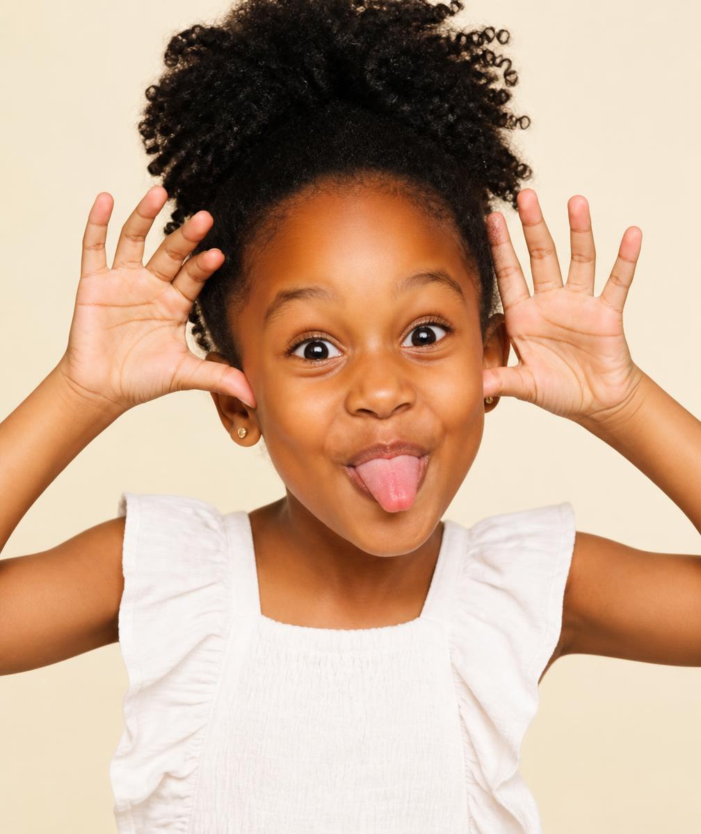Child practicing expressions in front of a camera