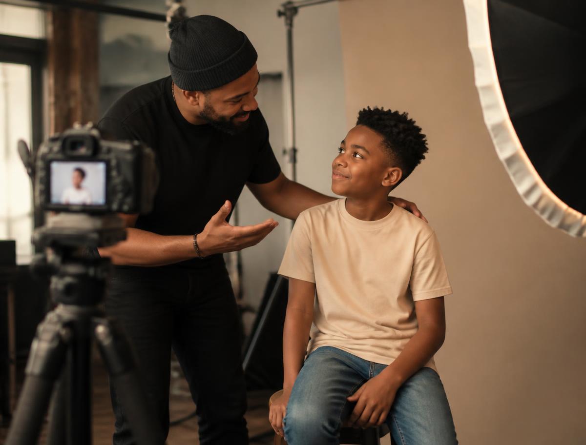 Photographer guiding a young talent through a test shoot
